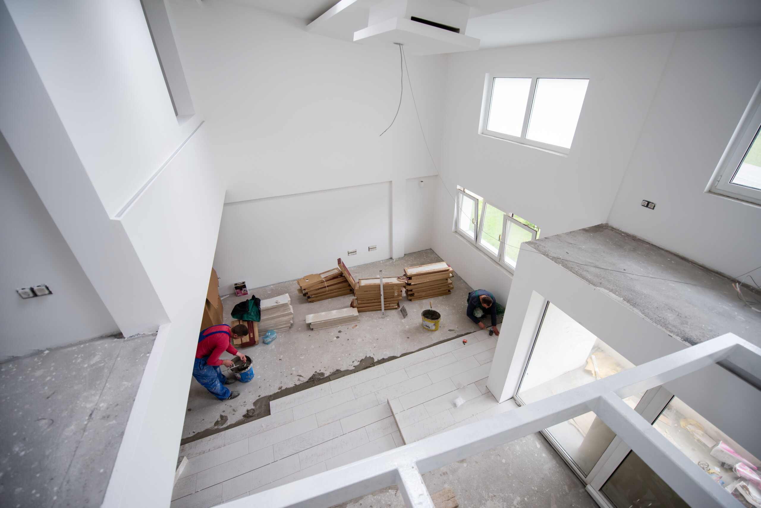 worker installing the ceramic wood effect tiles on the floor